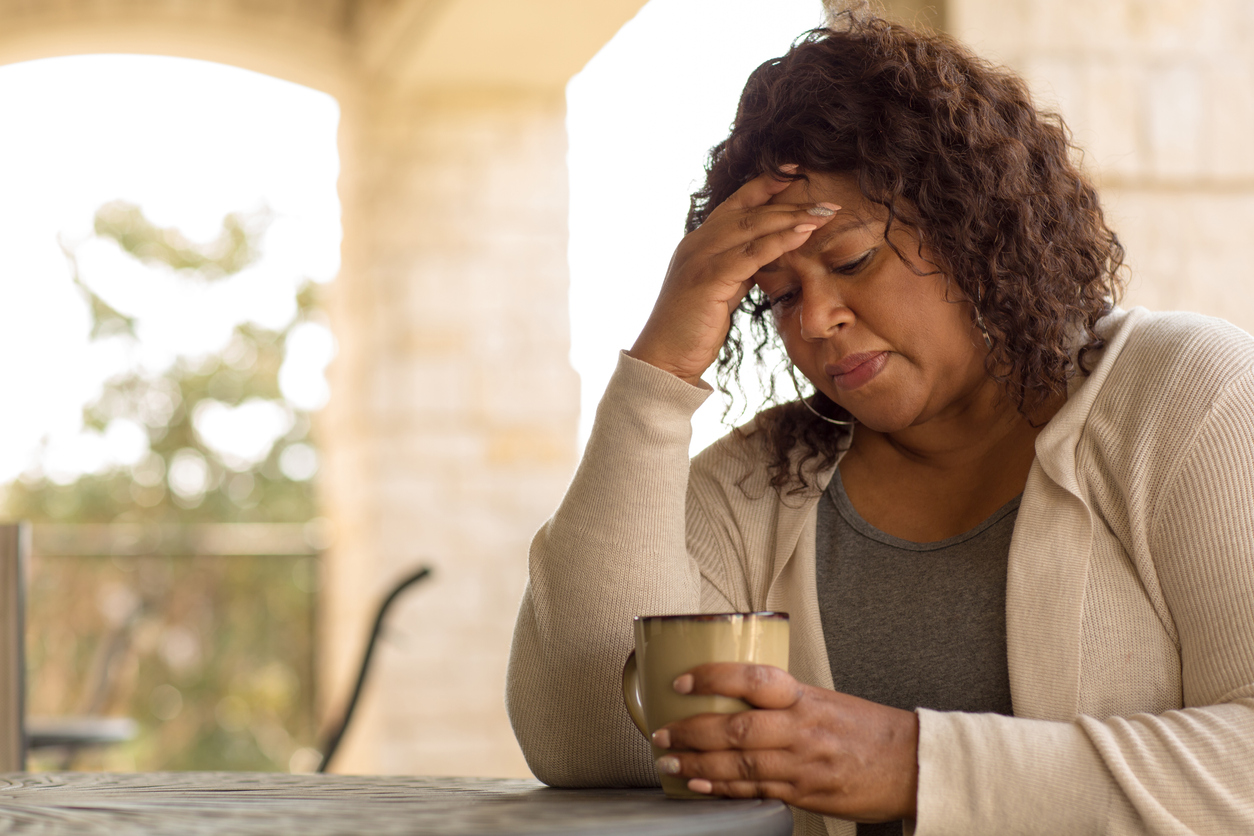 Sad woman looking upset and in pain. Chronic illness therapy in New Bern, NC can help with an nline therapist in North Carolina. Start online therapy for life changes counseling, anxiety, trauma, and more here!
