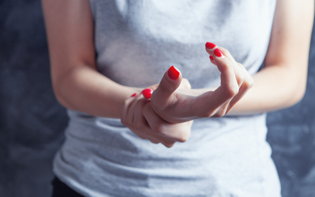 A close up of a person holding their wrist. This could represent the discomfort chronic illness counseling in New Bern, NC an address. Learn more about pain reprocessing therapy in New Bern, NC by contacting a chronic illness therapist today.