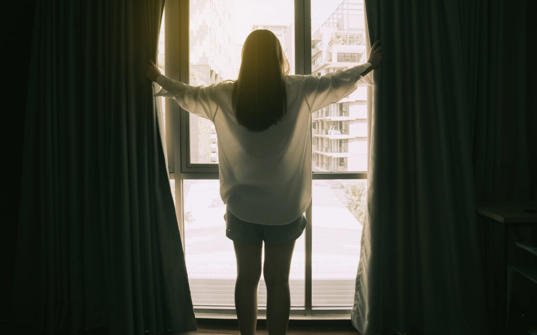Image of person looking out a window. This person could be using the month of may to reflect on their mental wellness as it is mental health awareness month in North Carolina. Get connected with an online therapist today. 27514 | 28608 | 28277