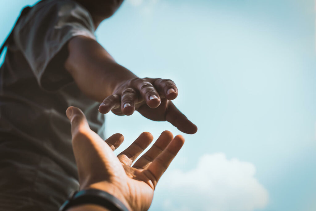 Hands reaching out to help each other. Chronic illness counseling in New Bern, NC can help you feel supported, even while suffering from chronic pain. Reach out for help here.
