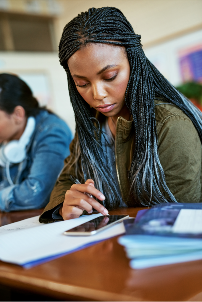 African American woman struggling to work effectively reflecting the challenges of adult ADHD. If you, too, are struggling with ADHD as an adult, therapy for adult ADHD in North Carolina is here to help.