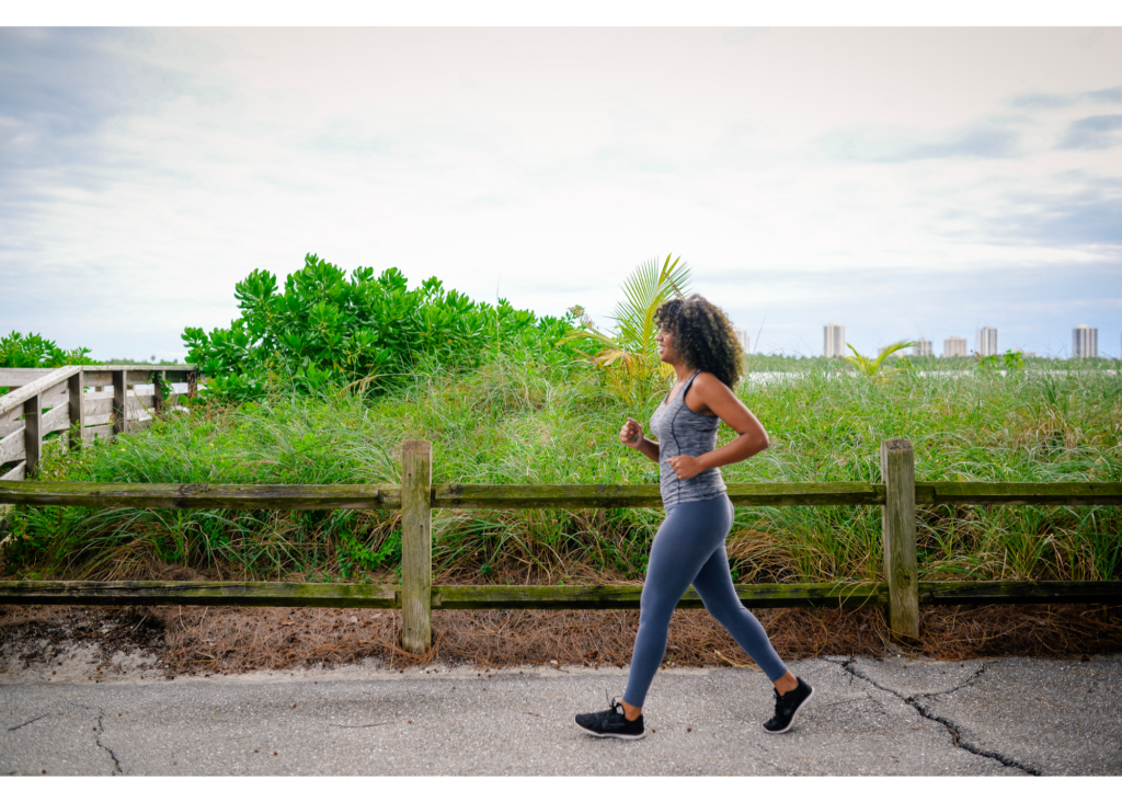 A woman jogs along a path, representing the benefits of movement for mental wellness in north carolina. Learn more about online therapy in north carolina by searching for “online therapy north carolina” today.