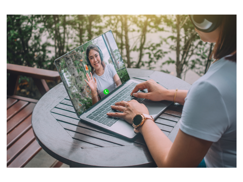 A person types on their laptop while on a video call with a friend. This could represent the support a young adult therapist in New Bern, NC can offer. Learn more about counseling for college students in New Bern, NC by searching for “therapist new bern, nc” today. 