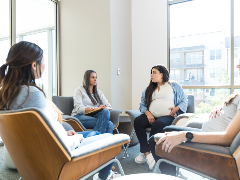 A group of pregnant women sit in a circle while listening to a person with a clipboard. Learn a New Bern therapist can offer support for new parents in New Bern, NC. They can offer anxiety treatment in New Bern, NC and other services. 