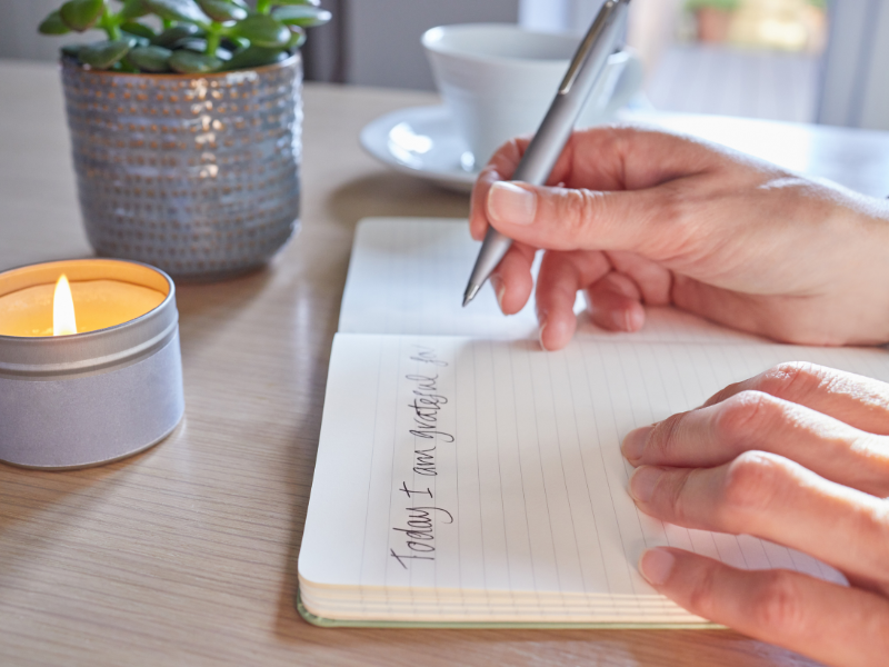 A close up of hands writing in a journal. The words written say “today i am grateful for”. Learn how a New Bern therapist can help you in maintaining mindfulness by searching for online therapy in North Carolina today. 