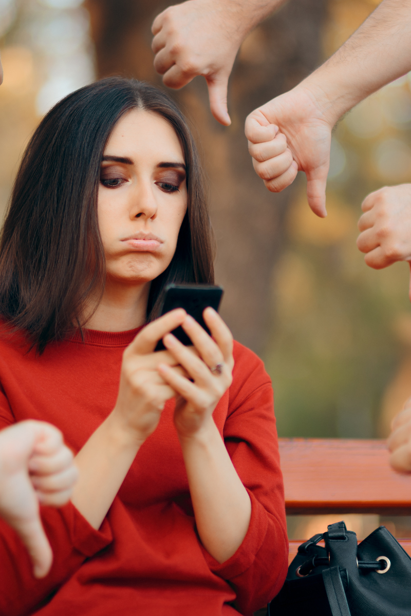woman staring at phone screen with sad face. Dark side of social media. Online Therapy. 28562