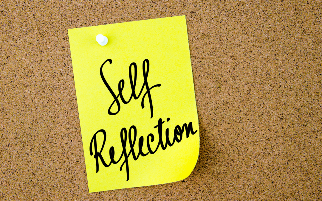 Self Reflection on a sticky note on a bulletin board. Self-reflection counseling in North Carolina.