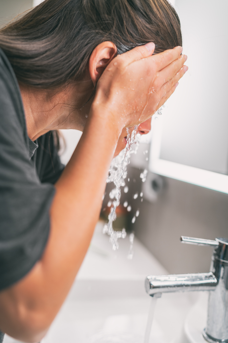 woman splashing water on her face, DBT, Distress Tolerance, 28562