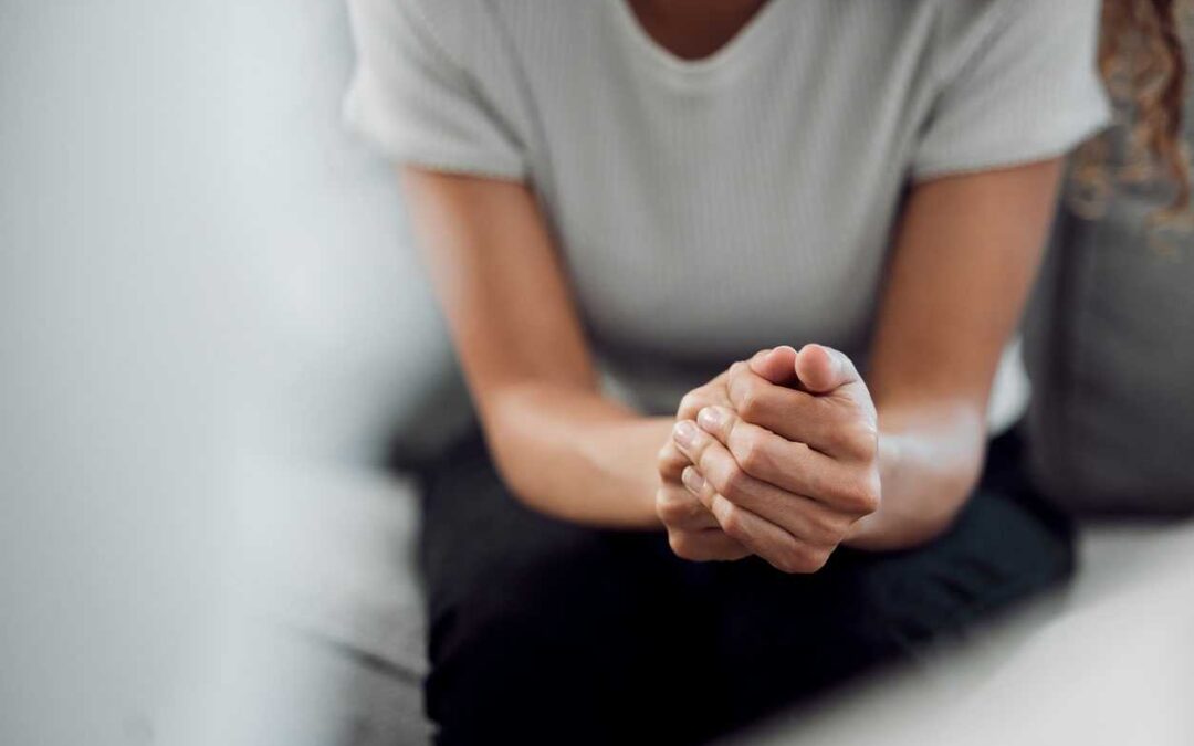 Cropped shot of an unrecognisable woman sitting alone and feeling anxious during her consultation