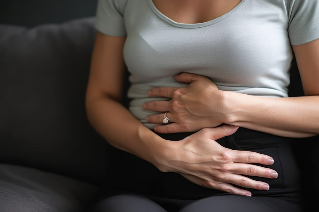 woman holding hands on her belly,