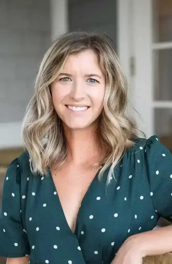 Alyssa Hermanson, LCSW, smiling in a green polka dot dress — accepting new telehealth clients in North Carolina.