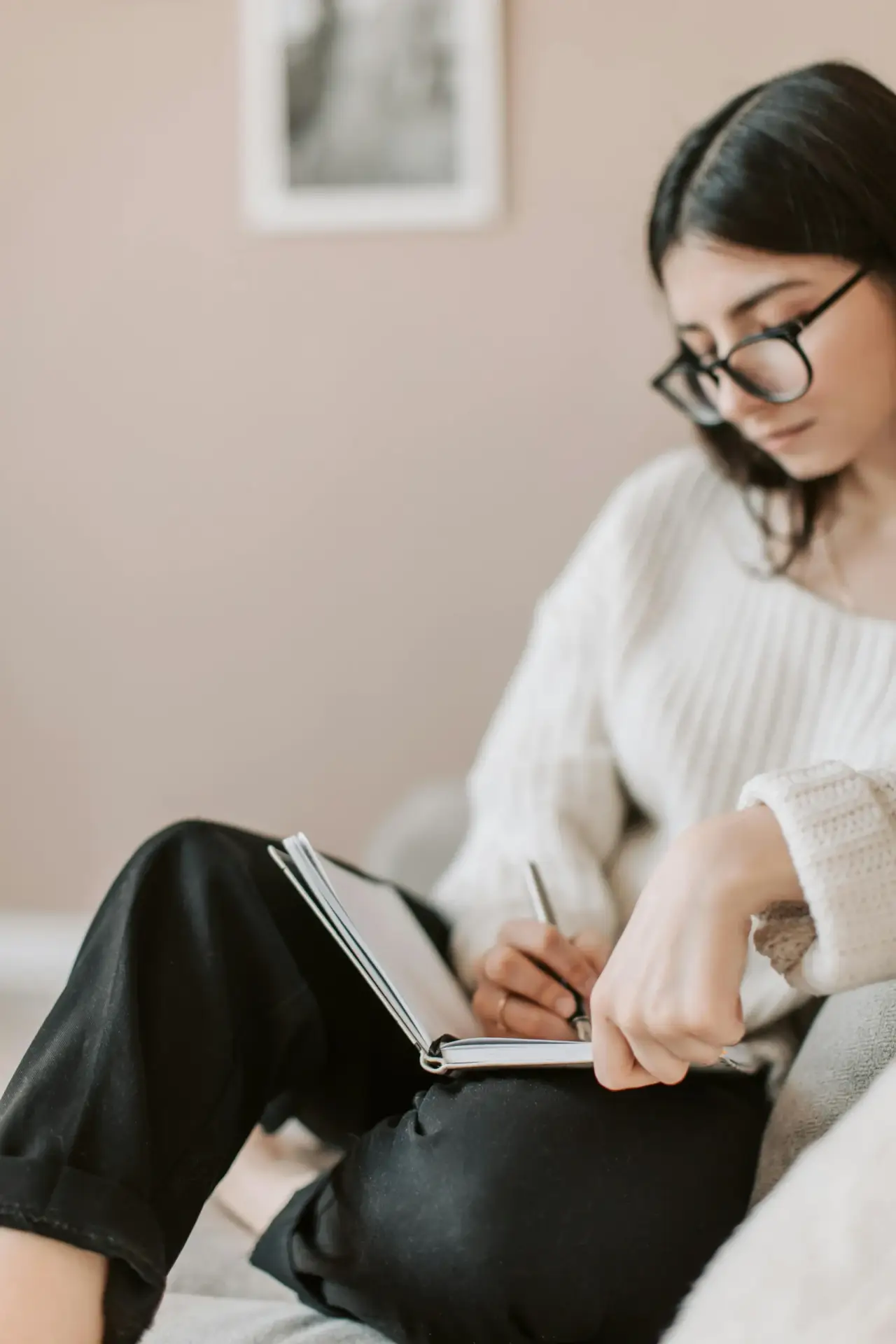 Woman journaling to stay mindful and grounded during holiday stress.