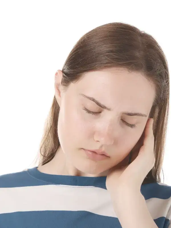 Woman holding jaw with closed eyes, representing jaw pain and physical symptoms of anxiety – therapy in New Bern NC