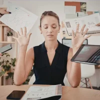 Woman appearing overwhelmed by competing demands, illustrating how ADHD and anxiety can affect focus, organization, and stress levels in women.